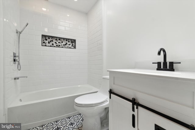 full bathroom with tiled shower / bath, vanity, and toilet