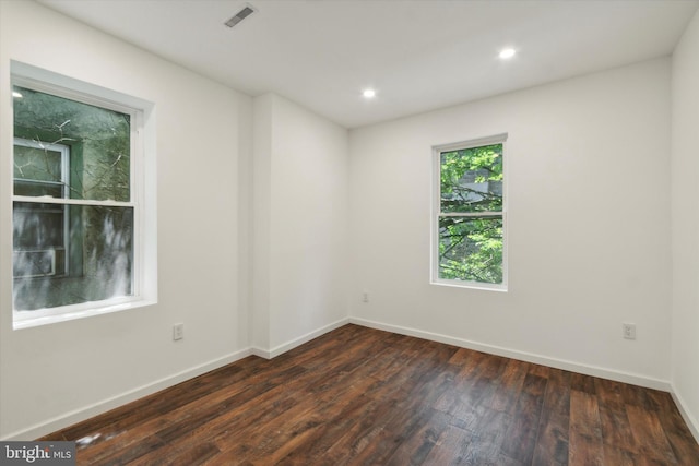 empty room with dark wood-type flooring