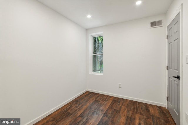 spare room with dark hardwood / wood-style flooring