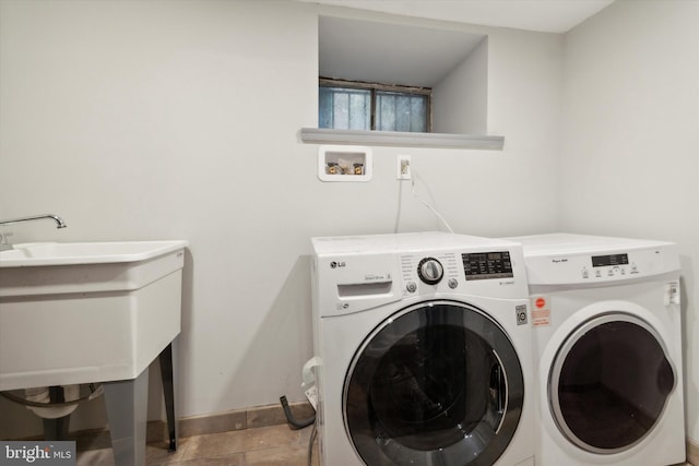 clothes washing area featuring tile patterned flooring and washer and clothes dryer