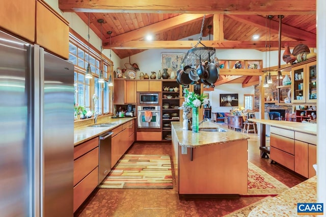 kitchen featuring a center island with sink, stainless steel appliances, lofted ceiling with beams, wood ceiling, and a sink