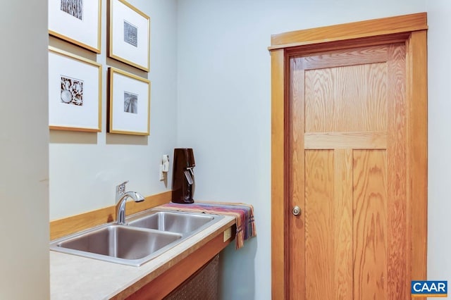 kitchen featuring light countertops and a sink