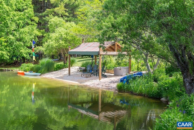 view of community featuring a patio area, a water view, and a gazebo