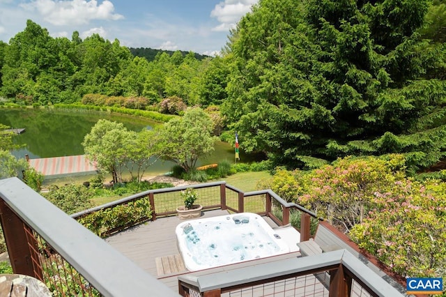 deck with a water view and hot tub deck surround