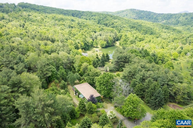 drone / aerial view featuring a wooded view