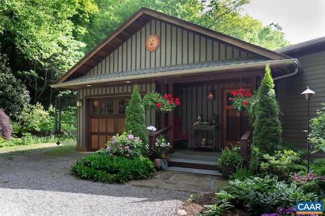 exterior space featuring a garage, a porch, and board and batten siding