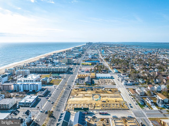 aerial view with a water view and a beach view