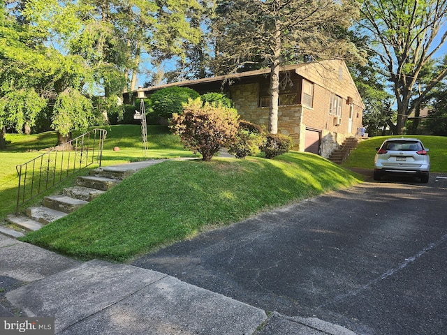 view of property exterior with a garage and a yard