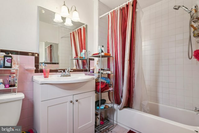 full bathroom with shower / bath combination with curtain, vanity, toilet, and tile walls