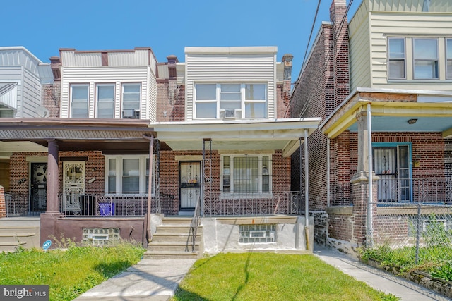 townhome / multi-family property with a porch