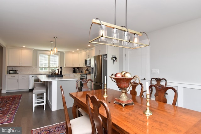 dining room with dark wood-type flooring