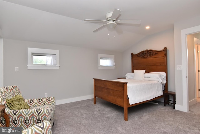 carpeted bedroom with ceiling fan, lofted ceiling, and multiple windows