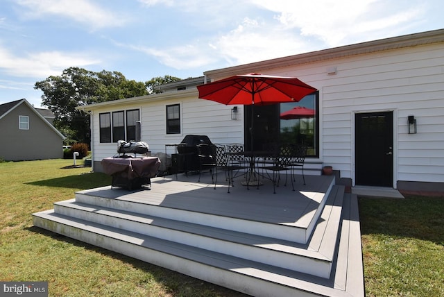 back of property featuring a yard and a deck