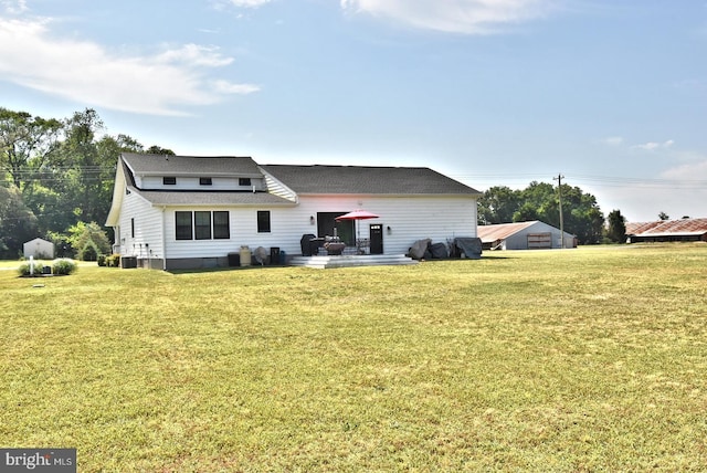 back of house with a lawn, cooling unit, and a patio