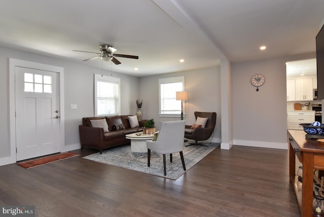 living room featuring dark hardwood / wood-style floors and ceiling fan