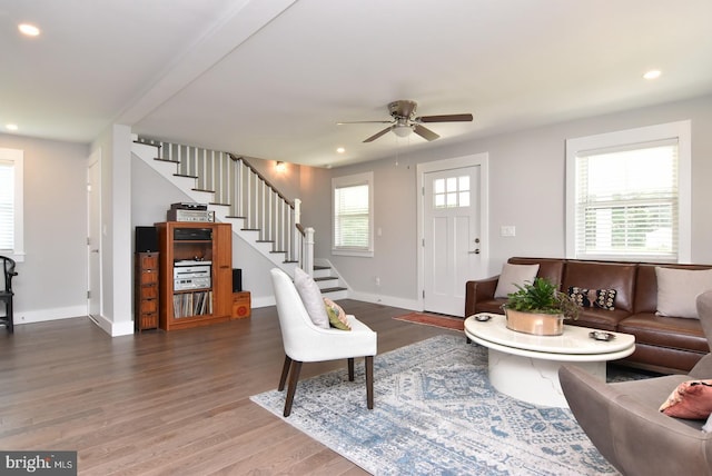 living room featuring hardwood / wood-style flooring, ceiling fan, and a wealth of natural light