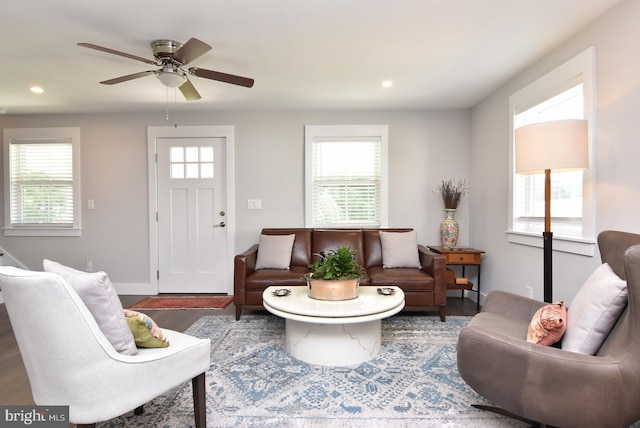 living room featuring dark hardwood / wood-style floors, a wealth of natural light, and ceiling fan