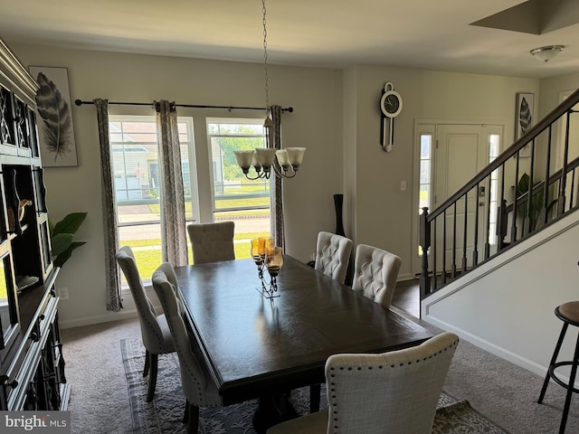 dining room featuring carpet and a notable chandelier