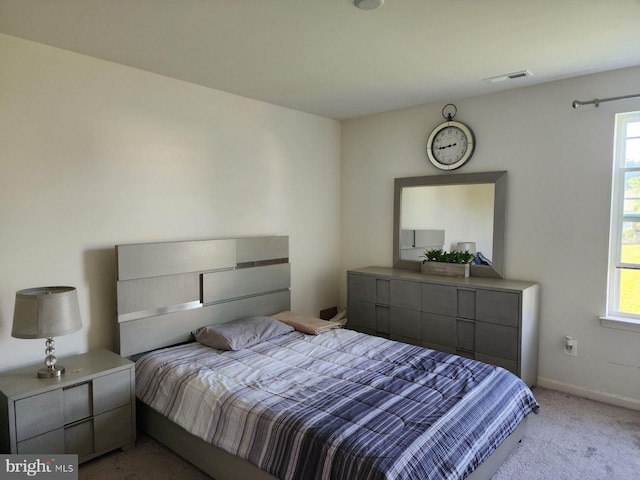 bedroom featuring light carpet