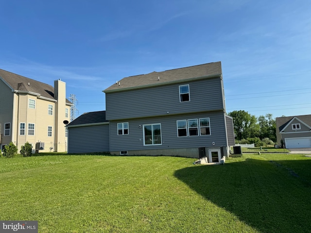 rear view of property featuring a yard and cooling unit