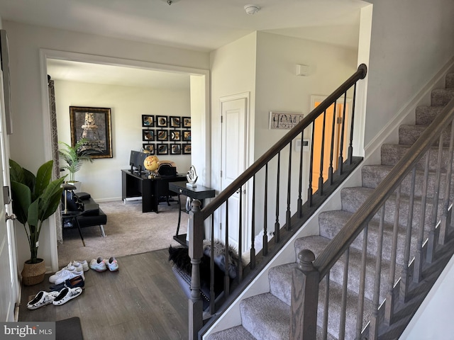 staircase featuring hardwood / wood-style flooring