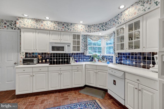 kitchen with white cabinets, white appliances, tasteful backsplash, and sink