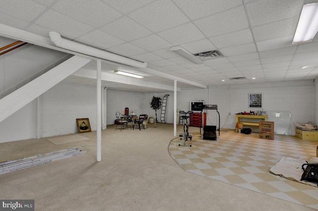 basement featuring carpet and a drop ceiling