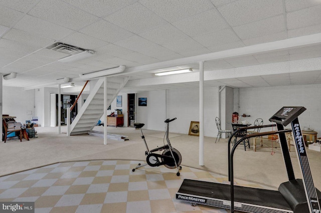 exercise area featuring carpet and a drop ceiling