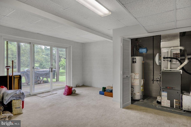 basement with carpet flooring, heating unit, and water heater