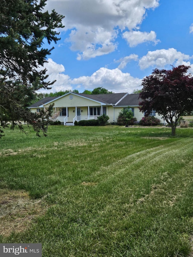 view of front of home featuring covered porch and a front yard