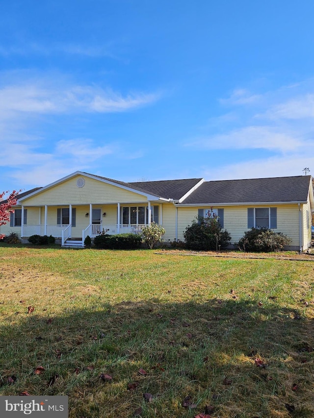 view of front of property with a porch and a front lawn