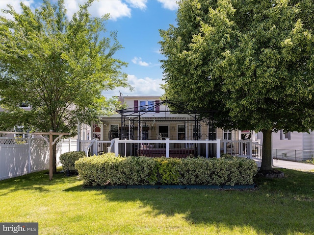 back of property featuring a gazebo and a lawn