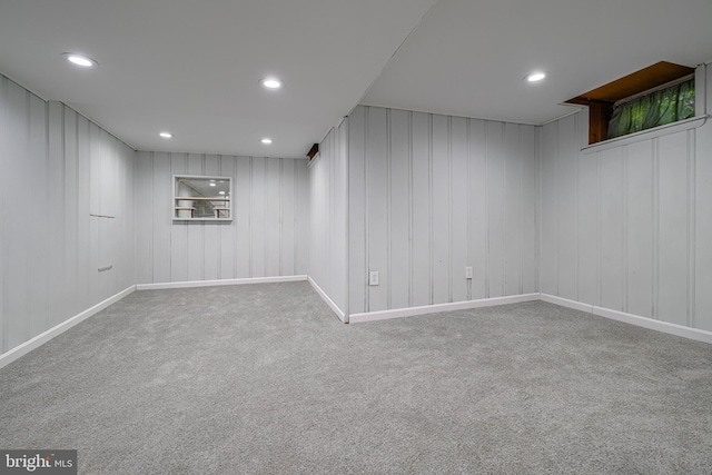 basement with wood walls and carpet floors