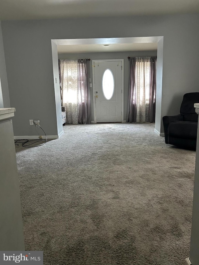 foyer entrance featuring carpet flooring