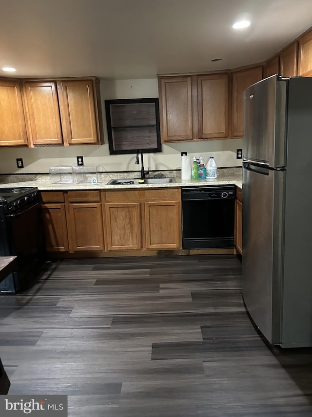 kitchen with sink, dark hardwood / wood-style floors, and black appliances