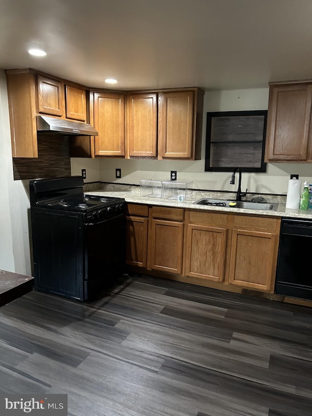 kitchen featuring dark wood-type flooring, sink, and black appliances