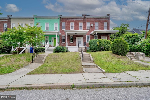 view of front of home featuring a front yard and a porch