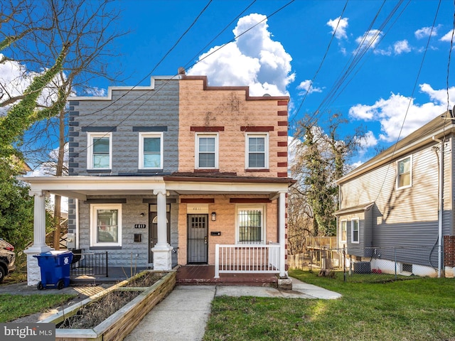 view of front of home with covered porch, central AC unit, and a front yard