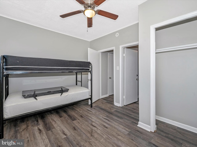 bedroom with ceiling fan, dark hardwood / wood-style flooring, and crown molding