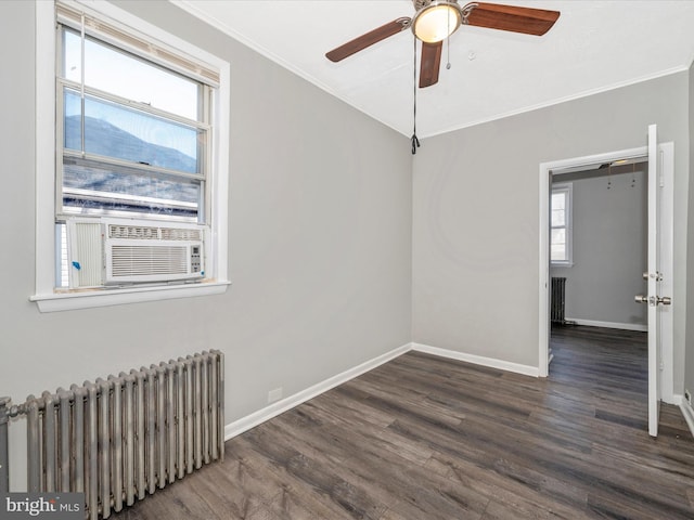 unfurnished room with radiator, a healthy amount of sunlight, dark hardwood / wood-style floors, and ornamental molding