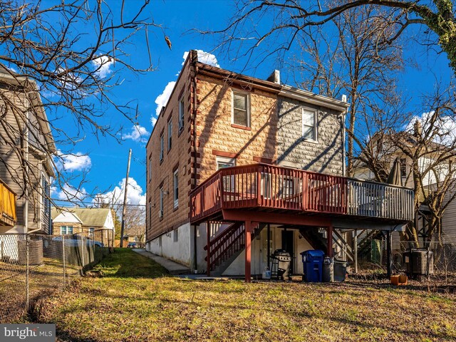 back of house with a yard and a deck