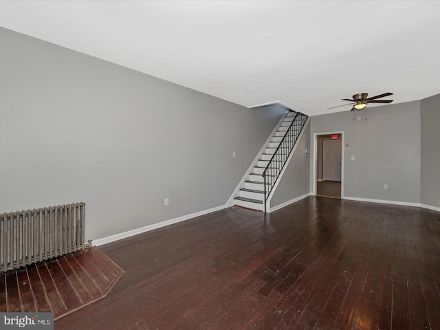 unfurnished living room featuring wood-type flooring, radiator heating unit, and ceiling fan