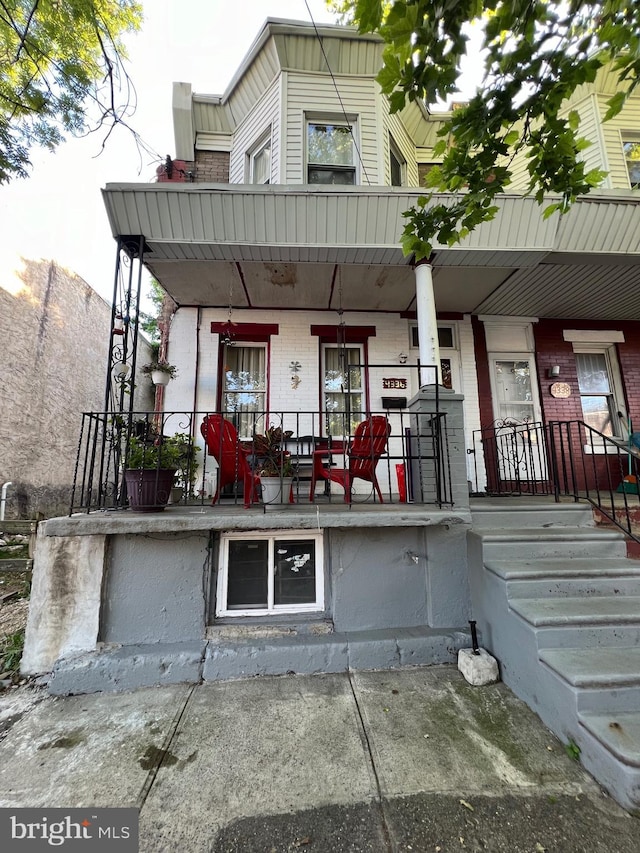 back of property with a porch