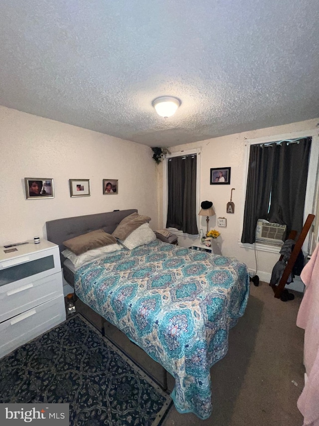 bedroom with carpet, a textured ceiling, and cooling unit