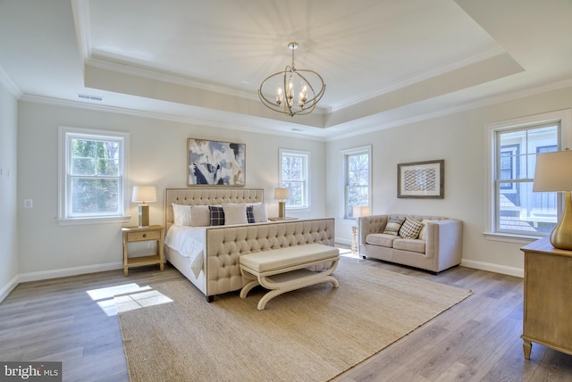 bedroom with crown molding, wood-type flooring, and a notable chandelier