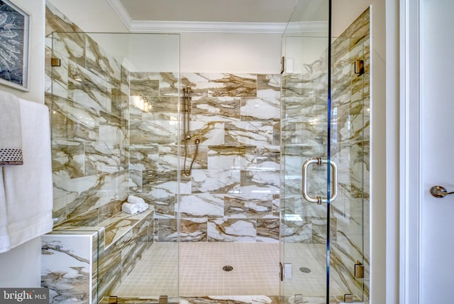 bathroom featuring ornamental molding and a shower with door