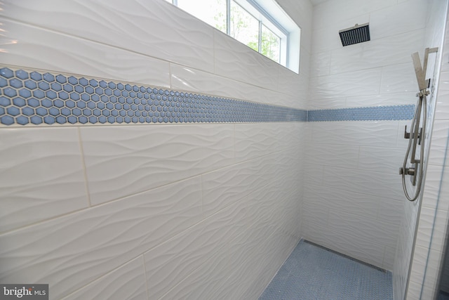 bathroom with tiled shower