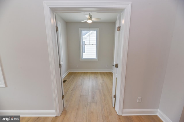 hallway with light wood-type flooring