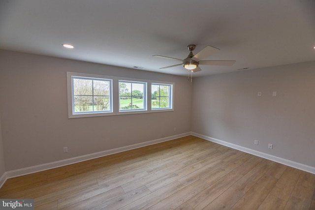 unfurnished room with ceiling fan and light hardwood / wood-style floors