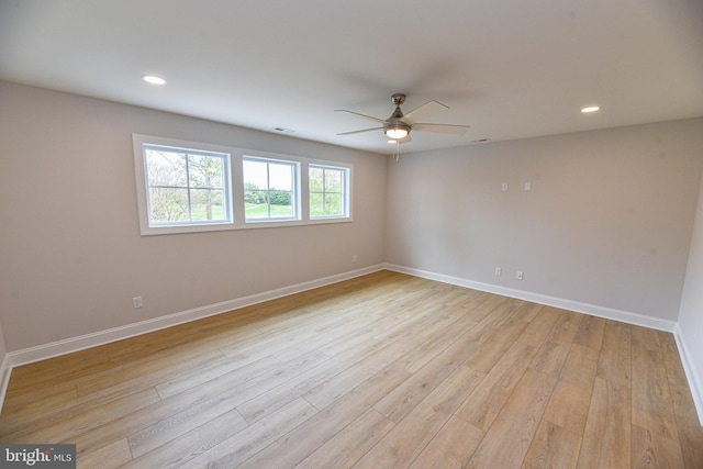 empty room with ceiling fan and light wood-type flooring